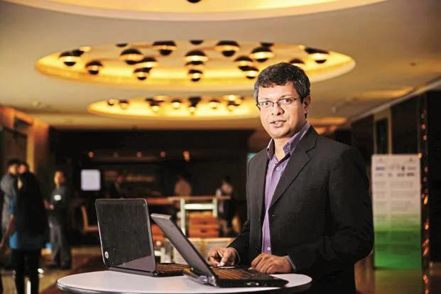 Sunil Abraham standing at a high table with a laptop in an indoor conference setting. Photo by Pradeep Gaur for Mint.
