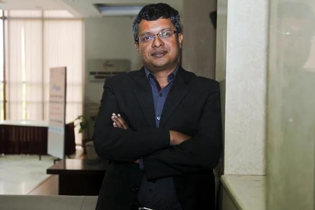 Sunil Abraham standing indoors with arms folded during an interview in New Delhi. Photo by Rituparna Banerjee for Mint.