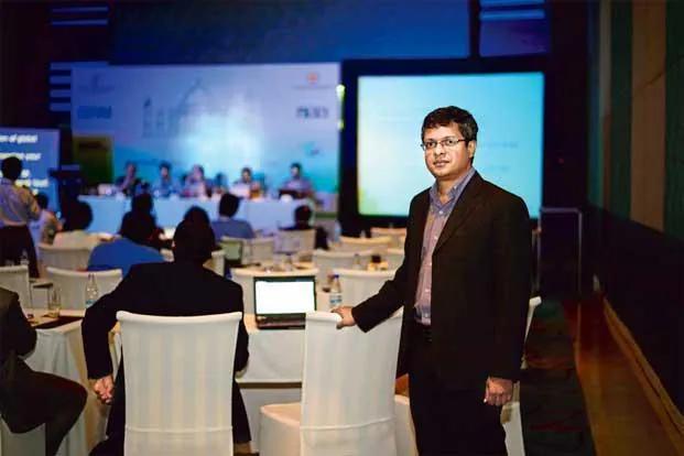 Sunil Abraham standing at a conference venue in Greater Noida, with panelists seated in the background. Photo by Pradeep Gaur for Mint.