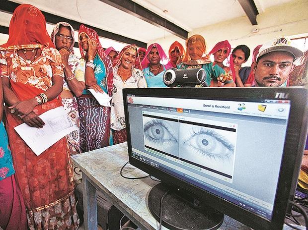 People queueing for Aadhaar registration, illustrating digital identity enrolment in India.